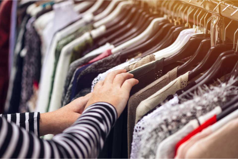Browsing clothing on an Op Shop rail